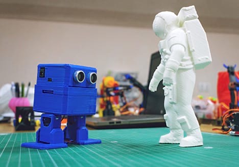 A blue printed robot facing a white astronaut figure
